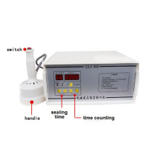 Máquina manual barata vendedora caliente del lacre del casquillo del sellador de la botella de la inducción, sellador de aluminio manual de la hoja de la botella